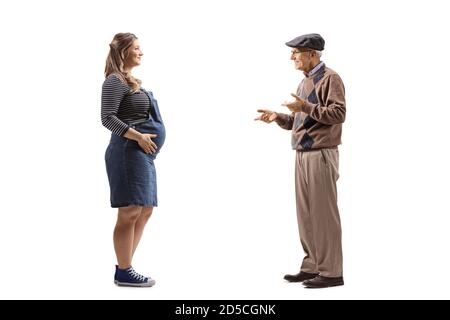 Full length profile shot of a pregnant woman and an elderly man having a conversation isolated on white background Stock Photo
