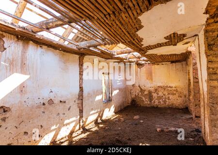 An old abandoned house. No people. The building is made of adobe and wood. Stock Photo