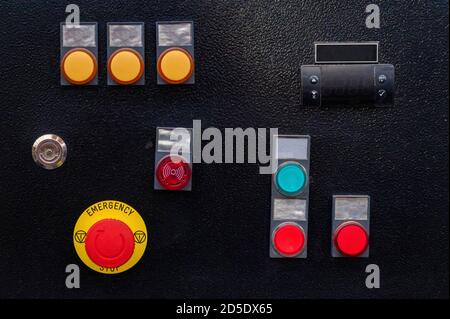 Industrial control panel at factory with yellow and red buttons Stock Photo