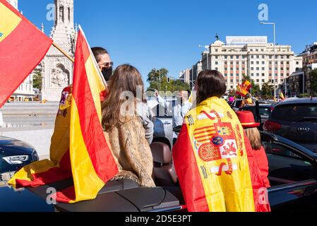 Madrid, Spain, 12th oct 2020.  People with mask waving flag as they attend a protest against Spanish government's handling of the COVID-19 crisis. Stock Photo