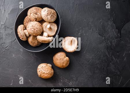 Shiitake mushrooms set on black background top view space for text. Stock Photo