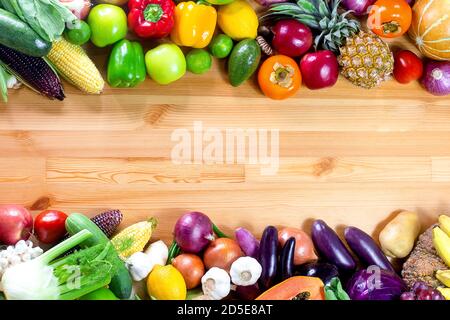 Fresh vegetables and fruits on a wooden background with copy space,Colorful fruits and vegetables,clean eating,vegetables and fruits background,top vi Stock Photo