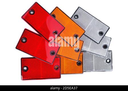 reflectors of red, white and yellow color to indicate car trailers and dimensions of objects and cars in the dark, on a white background close-up Stock Photo