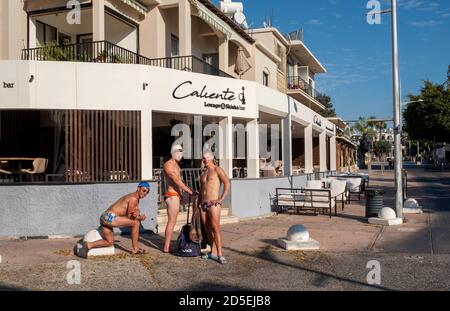 Paphos, Cyprus. 13th Oct 2020. Three British tourists pose for pictures on Bar Street in the deserted tourist area of Kato Paphos during the Coronavirus Pandemic.  Bar Street, Paphos, Cyprus. 13th October, 2020.    Credit: Ian Rutherford/Alamy Live News. Stock Photo