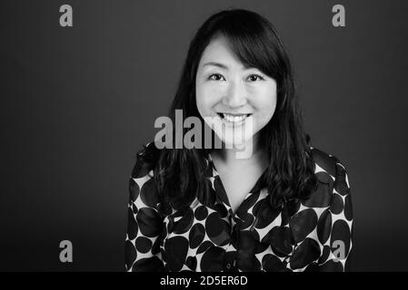 Portrait of happy mature beautiful Asian businesswoman Stock Photo