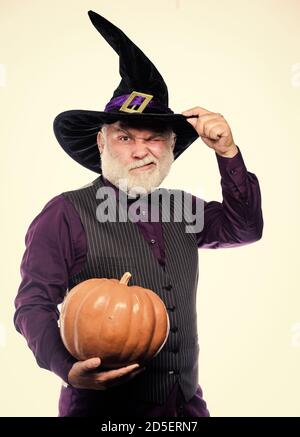 Magic concept. Experienced and wise. Magic spell. Halloween tradition. Cosplay outfit. Senior man white beard celebrate Halloween. Wizard costume hat Halloween party. Magician witcher old man. Stock Photo