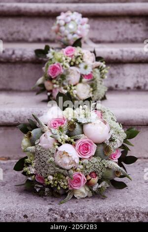 Pastel coloured bridal bouquets of flowers with pink roses, white rose and gypsophila
