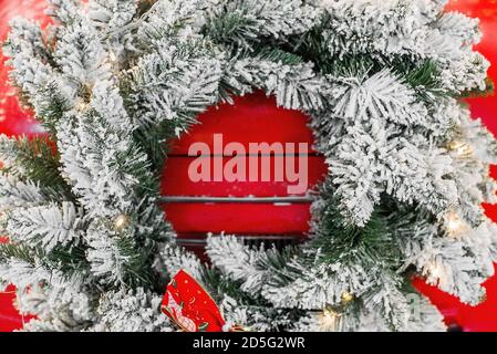 Magic card in red color. Decorated retro car with festive New Year lights, garlands, branches of Christmas trees, gift boxes in white-green wrapping Stock Photo