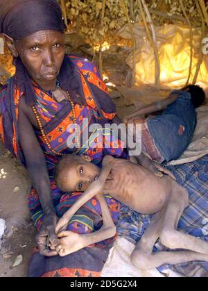 Ethiopian woman holds a malnourished child at a camp in the town of Danan, 600 kms south-east of Addis Ababa on  April 7. Eight children are dying every day from famine in Ethiopia's remote Ogaden region. Close to eight million Ethiopians are threatened by drought and will need food aid this year after a string of failed rainy seasons.
