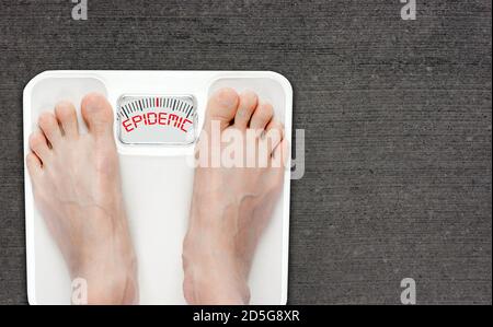 Feet on bathroom scale with the word EPIDEMIC on screen. Obesity has reached epidemic proportions globally, with more than 1 billion adults overweight Stock Photo