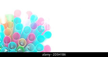 Unusual top view of many isolated multicolored plastic cocktail tubes on white background. Drinking straws of bright neon colors. Light effect Stock Photo