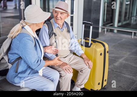 Two senior people having a conversation on the bench Stock Photo