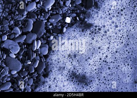 Photo of sea waves and pebbles on the beach Stock Photo