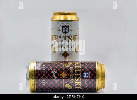 KYIV, UKRAINE - JULY 23, 2020: Keltske Dedictvi Czech light and dark lager beer cans closeup against white bacground, focus on foreground. Produced by Stock Photo