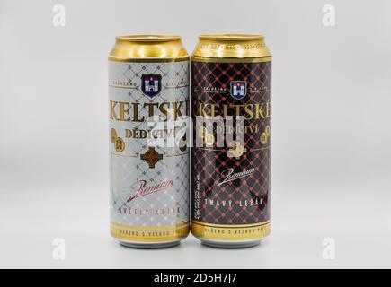 KYIV, UKRAINE - JULY 23, 2020: Keltske Dedictvi Czech light and dark lager beer cans closeup against white bacground, focus on foreground. Produced by Stock Photo