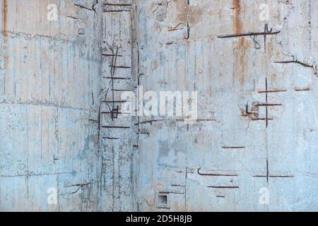 Reinforced concrete with damaged and rusty steel reinforcement. Old distressed wall texture background, steel bars and mesh visible corrosion Stock Photo