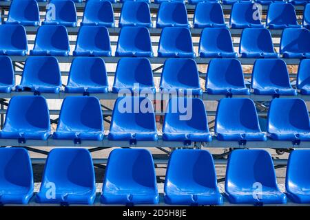 Stadium seats background. Rows of blue plastic empty seats. Sports or concerts audience chairs Stock Photo