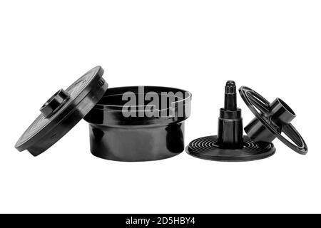Tank and reel for development 35mm film. Kit for developing film includes film spiral roller and developing container. Isolated on a white background. Stock Photo