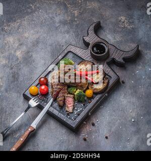 Grilled and sliced beek steak with vegetables, copy space Stock Photo