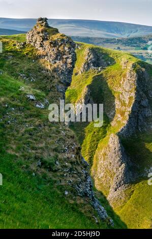 Prominent outcrop of rock high above the deep gorge of reef limestone at Winnats Pass, Castleton, Derbyshire. Stock Photo