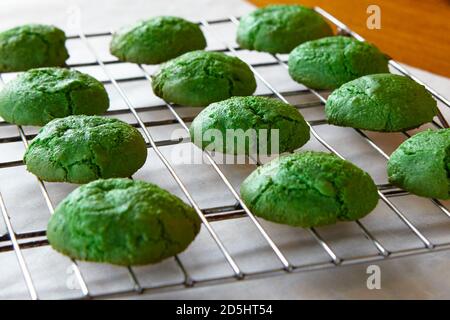 Green pistachio cookies cooling on a baker's rack. Stock Photo