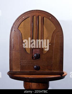 Antique Philco cathedral style radio on pedestal table. Stock Photo