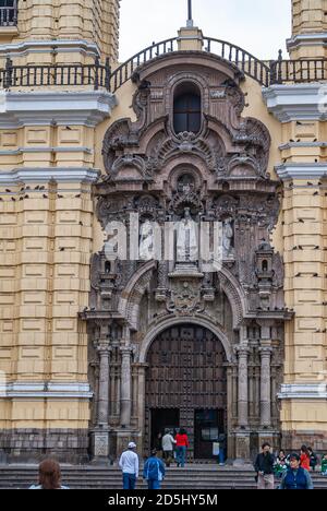 Lima, Peru - December 4, 2008: Closeup of monumental entrance to convent and church of San Francisco with statues and people on the steps. Stock Photo