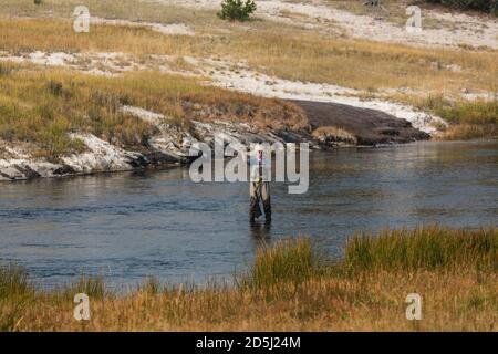 A fly fisherman on the Firehole River in Yellowstone National Park in Wyoming. Stock Photo