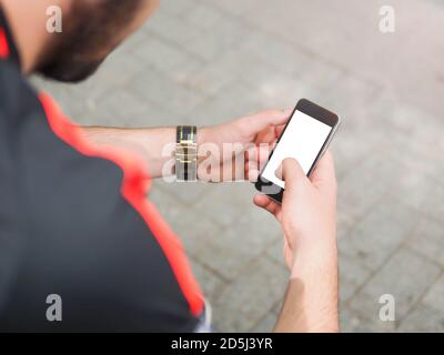Unrecognizable man using phone with white blank screen. Lifestyle education student. Businessman work on cell for project. Millennial at home office d Stock Photo