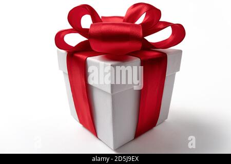 White gift box with red ribbon bow, isolated on white Stock Photo