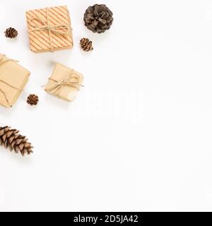 Gift boxes with pine cones on white background. Autumn and winter concept. flat lay, top view, copy space Stock Photo