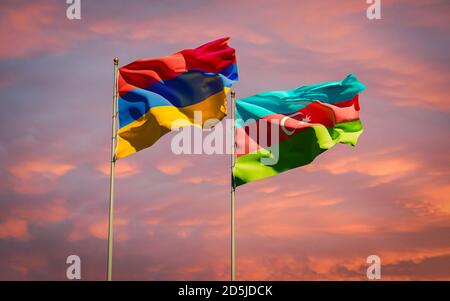 Armenia and Azerbaijan flags together waving in the sky background. Concept of relations between two countries during Nagorno-Karabakh war conflict cr Stock Photo