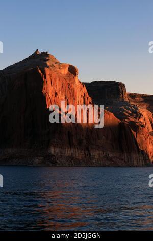 Lake Powell, Arizona, USA. 13th Aug, 2020. Sunset on red rock canyons. Lake Powell is a man-made reservoir on the Colorado River in Glen Canyon National Recreation Area and straddles 2 western states Utah and Arizona. It is a major vacation spot, stretching from the beginning of the Grand Canyon in Arizona to southern Utah, Glen Canyon National Recreation Area is graced with scenic views, unique geology and 10,000 years of human history. Activities include boating, fishing, hiking. Lake Powell, is the second largest man made lake in the United States, and is a premier boating destination. Ris Stock Photo