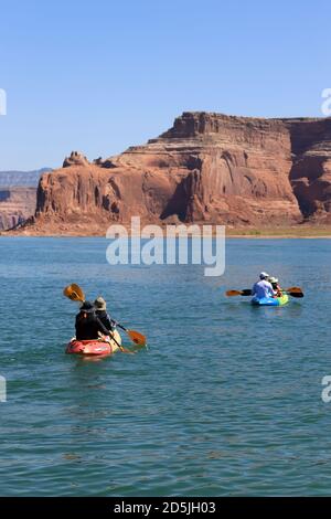 Lake Powell, Arizona, USA. 13th Aug, 2020. Kayakers enjoys Lake Powell scenery. Lake Powell is a man-made reservoir on the Colorado River in Glen Canyon National Recreation Area and straddles 2 western states Utah and Arizona. It is a major vacation spot, stretching from the beginning of the Grand Canyon in Arizona to southern Utah, Glen Canyon National Recreation Area is graced with scenic views, unique geology and 10,000 years of human history. Activities include boating, fishing, hiking. Lake Powell, is the second largest man made lake in the United States, and is a premier boating destina Stock Photo