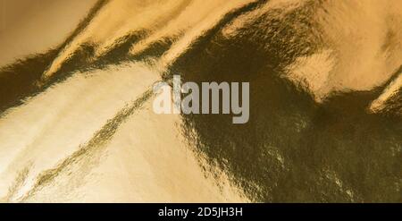 Gold foil texture background. Gold texture and gradients shadow. Stock Photo