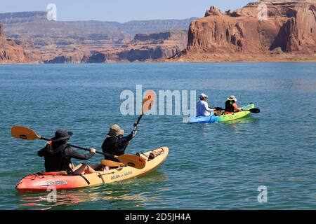 Lake Powell, Arizona, USA. 13th Aug, 2020. Kayakers enjoys Lake Powell scenery. Lake Powell is a man-made reservoir on the Colorado River in Glen Canyon National Recreation Area and straddles 2 western states Utah and Arizona. It is a major vacation spot, stretching from the beginning of the Grand Canyon in Arizona to southern Utah, Glen Canyon National Recreation Area is graced with scenic views, unique geology and 10,000 years of human history. Activities include boating, fishing, hiking. Lake Powell, is the second largest man made lake in the United States, and is a premier boating destina Stock Photo