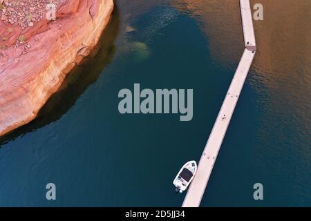 Lake Powell, Arizona, USA. 13th Aug, 2020. Aerial view of boat and marina above the canyons near Rainbow Bridge. Lake Powell is a man-made reservoir on the Colorado River in Glen Canyon National Recreation Area and straddles 2 western states Utah and Arizona. It is a major vacation spot, stretching from the beginning of the Grand Canyon in Arizona to southern Utah, Glen Canyon National Recreation Area is graced with scenic views, unique geology and 10,000 years of human history. Activities include boating, fishing, hiking. Lake Powell, is the second largest man made lake in the United States, Stock Photo