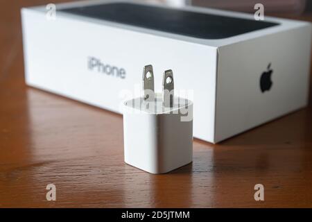 Bangkok, Thailand - October 14, 2020 : An old Power Adapter for iPhone with iPhone 7 packaging box. Stock Photo