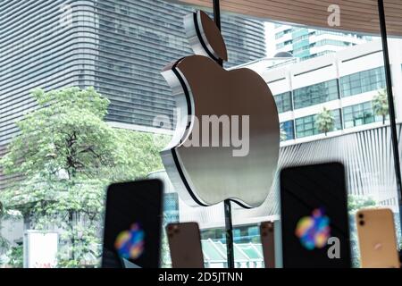 Bangkok, Thailand - September 14, 2020 : The Apple logo on Apple Store in Bangkok with iPhones in the foreground. Stock Photo