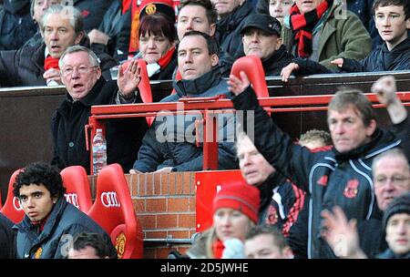 Manchester United manager Alex Ferguson (left) and Liverpool manager Kenny Dalglish (right) watch the action from the bench Stock Photo