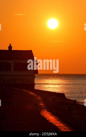 New Forest, Hampshire. 14th October 2020. UK Weather. Sunrise behind the old Coastguard Watch House on Lepe Beach in the New Forest. Credit Stuart Martin/Alamy Live News Stock Photo