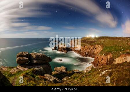 Longships Lighthouse from Land's End; At Night with Moonlight and Star Trails; Cornwall; UK Stock Photo