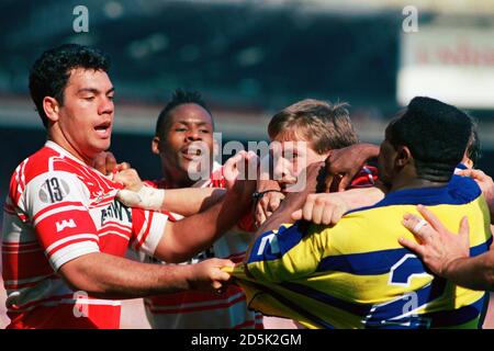 (L-R) Kevin Iro (Wigan) and Des Drummond (Warrington) do not see eye to eye after Iro's second try. Stock Photo
