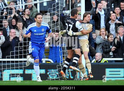 Newcastle United goalkeeper Tim Krul (right) celebrates with team mate Steven Taylor after saving a penalty from Chelsea's Frank Lampard (left) Stock Photo
