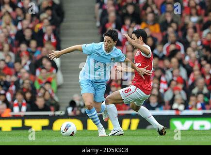 Arsenal's Mikel Arteta (right) and Manchester City's Samir Nasri (left) battle for the ball Stock Photo