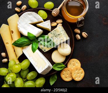 Various types of cheese  on a black concrete background Stock Photo