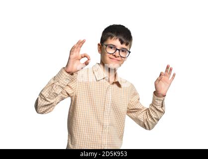 Cute Caucasian white boy in glasses showing hands gesture OK everything is fine, on white isolated background Stock Photo