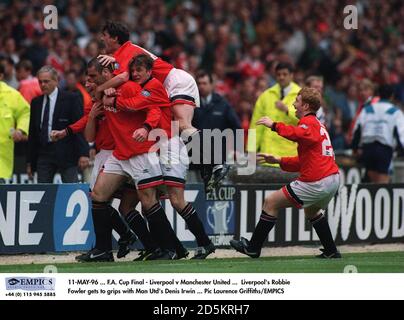 Manchester United's Eric Cantona is mobbed by teammates after scoring the winning goal Stock Photo