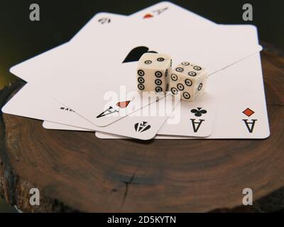 Ace playing cards with wite bone dice. Casino betting and gambling concept. Close up Stock Photo