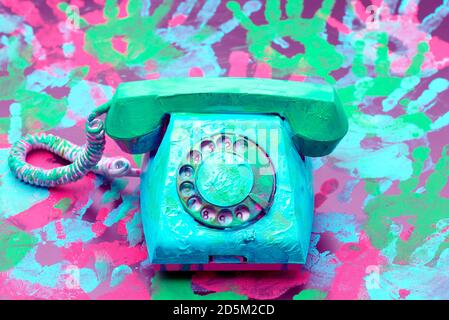 A vintage dial phone from the 80s in abstract vivid colors.  Retro style landline telephone art. Stock Photo